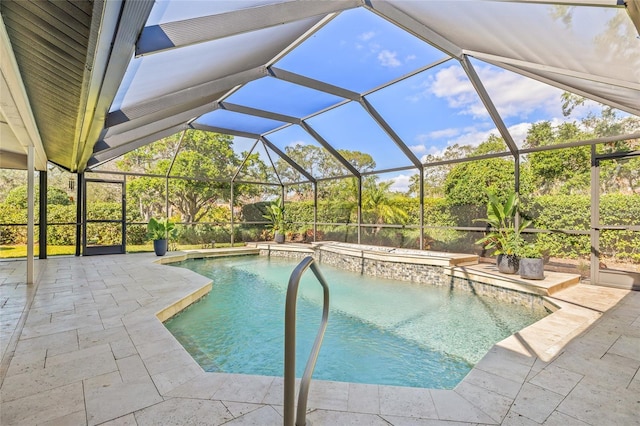 view of swimming pool with a patio and glass enclosure