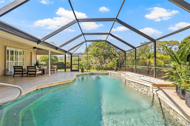 view of pool featuring outdoor lounge area, ceiling fan, a lanai, and a patio