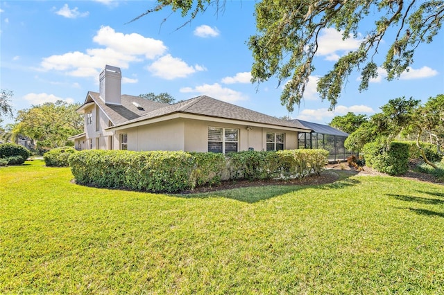 view of property exterior featuring a lanai and a lawn