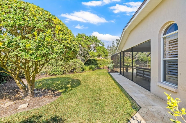 view of yard featuring a patio area and glass enclosure