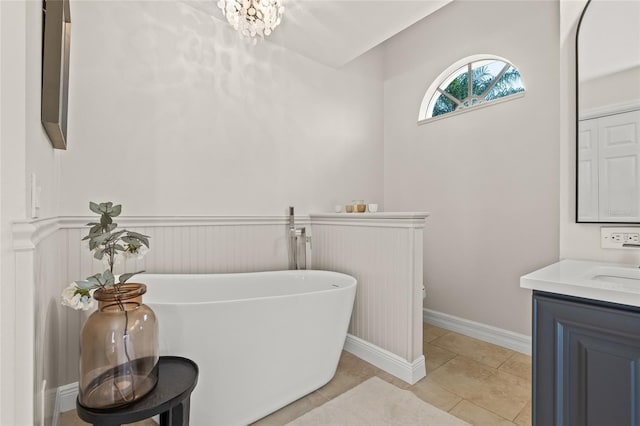 bathroom with vanity, a tub, and tile patterned floors