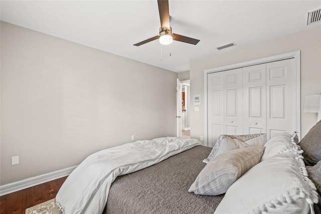 bedroom featuring hardwood / wood-style flooring, a closet, and ceiling fan