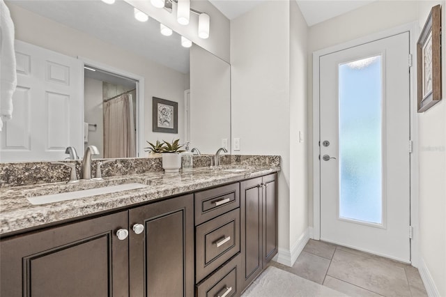 bathroom with vanity, curtained shower, and tile patterned floors