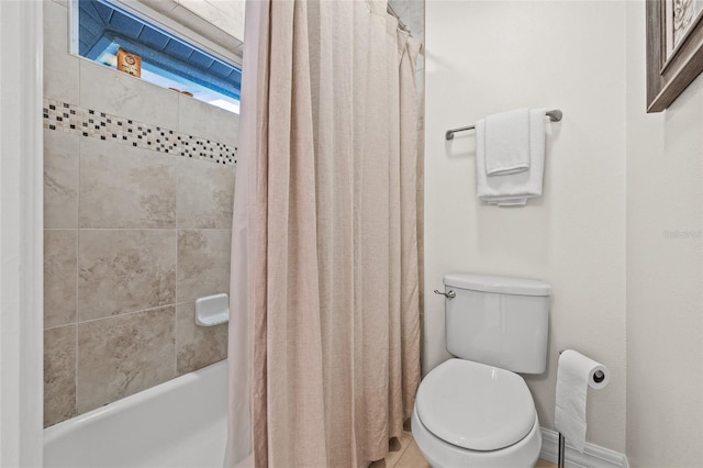 bathroom featuring shower / bath combo and toilet