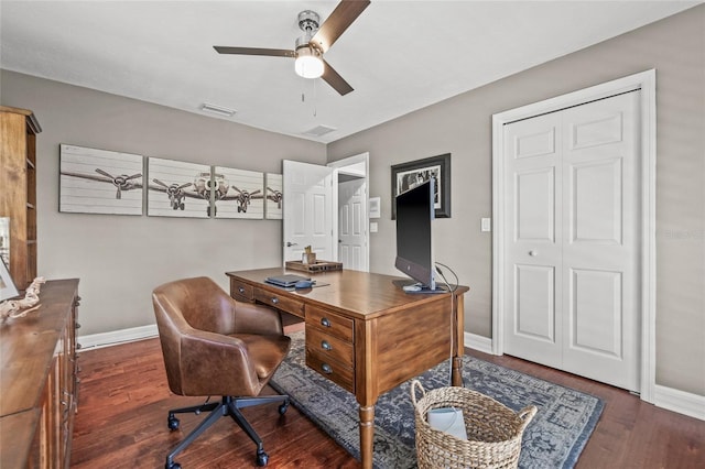 home office with dark hardwood / wood-style floors and ceiling fan