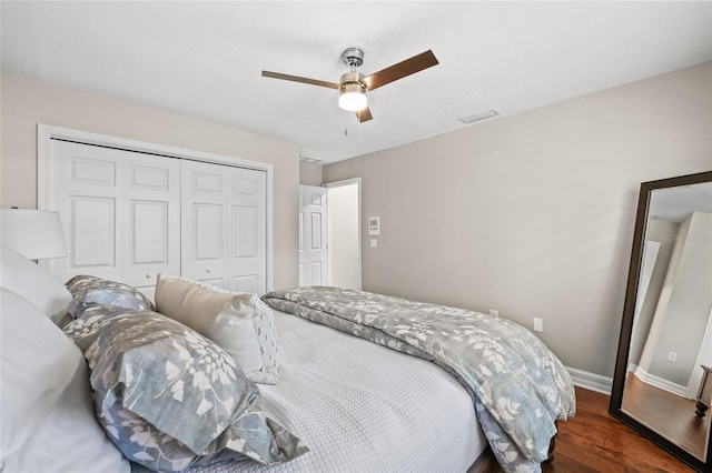 bedroom with ceiling fan, dark hardwood / wood-style floors, and a closet