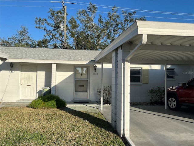 entrance to property with a lawn