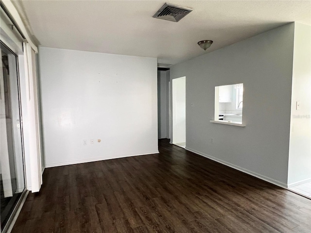 empty room featuring dark hardwood / wood-style flooring