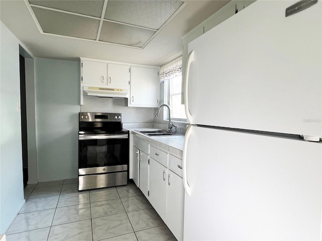 kitchen with sink, white cabinetry, white refrigerator, tile counters, and electric stove