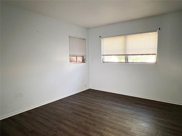 unfurnished room featuring dark wood-type flooring