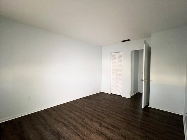 spare room featuring dark hardwood / wood-style floors