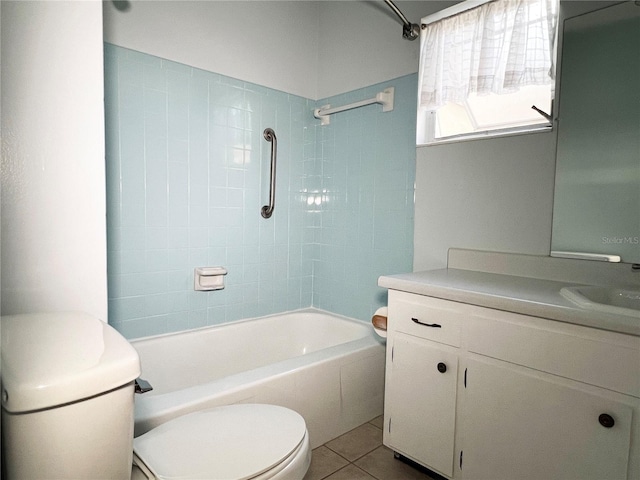 full bathroom with tile patterned flooring, vanity, tiled shower / bath combo, and toilet