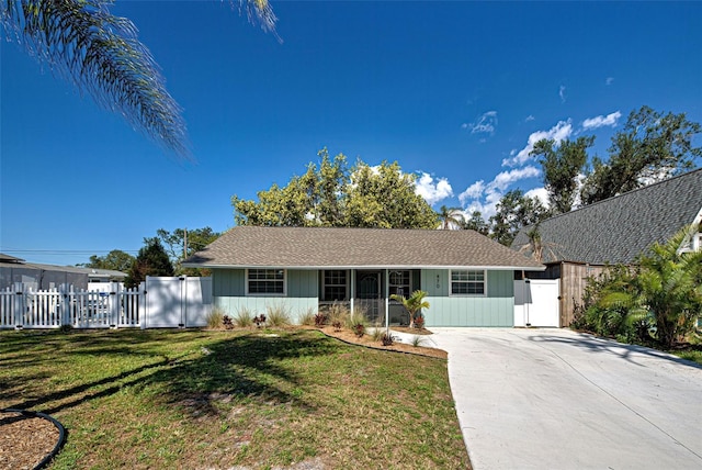 ranch-style home with a gate, fence, and a front lawn