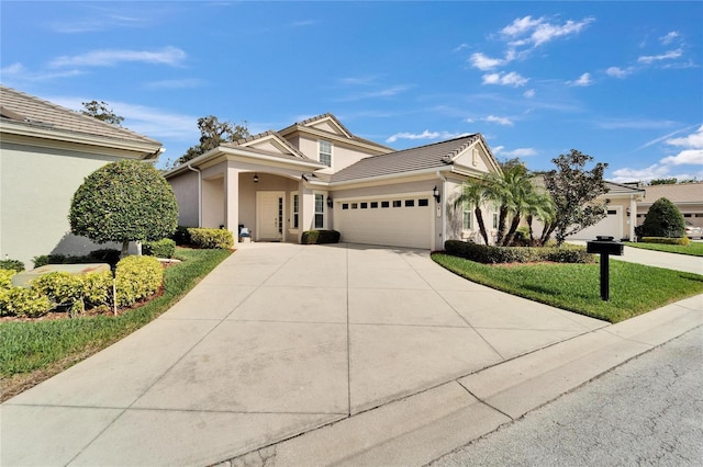 view of front facade featuring a garage and a front lawn