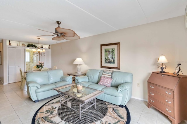 living room with ceiling fan with notable chandelier and light tile patterned floors