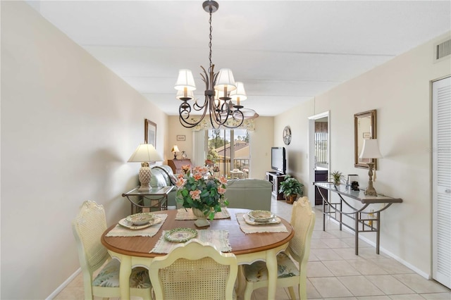 tiled dining space with a notable chandelier