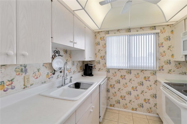 kitchen with sink, white cabinets, light tile patterned floors, ceiling fan, and white appliances