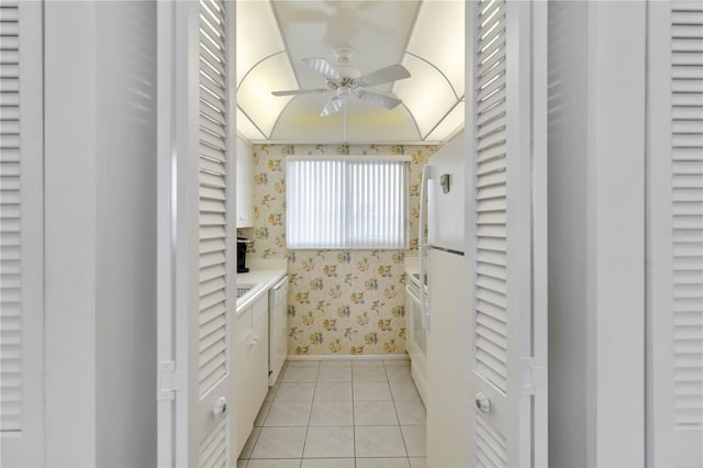 bathroom featuring ceiling fan, stacked washer / drying machine, and tile patterned flooring