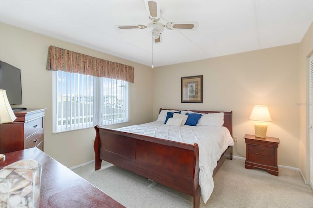 bedroom with light carpet and ceiling fan