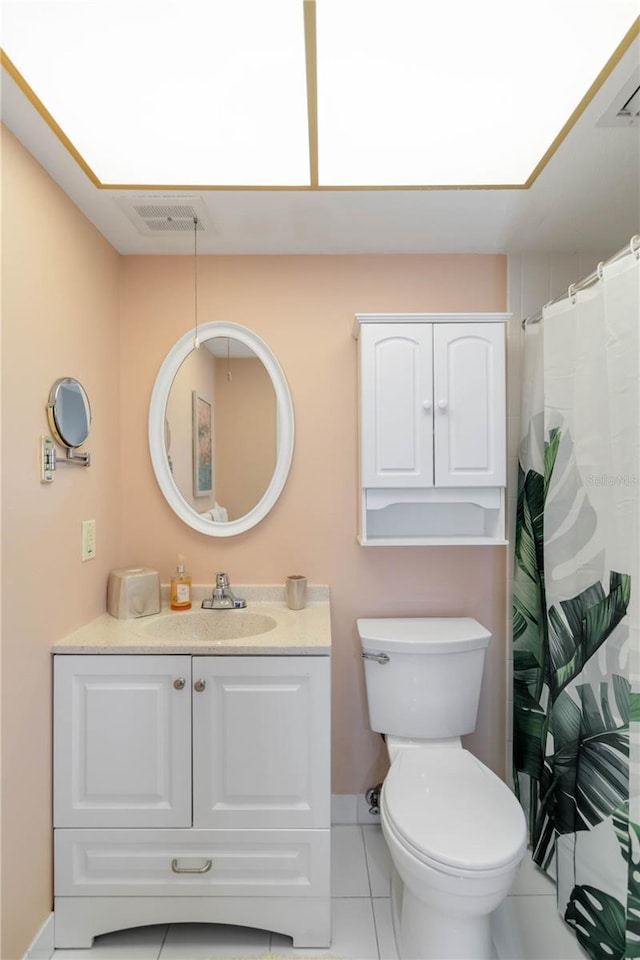 bathroom featuring vanity, tile patterned floors, and toilet