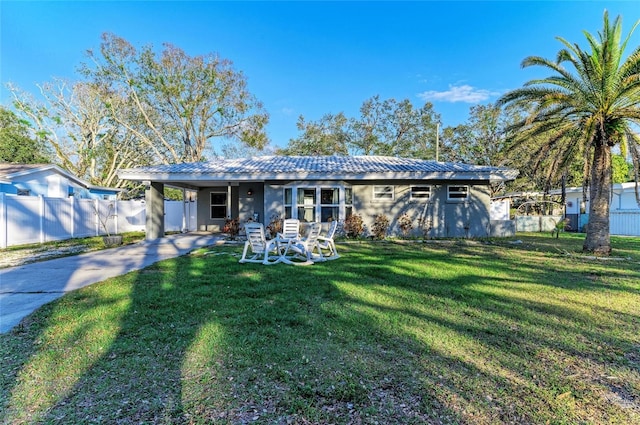 view of front facade with a front yard and a carport