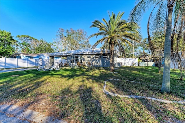 back of property featuring a lawn