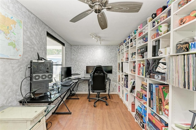 home office with ceiling fan and light hardwood / wood-style floors