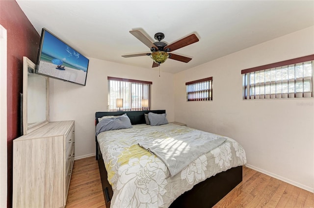 bedroom with ceiling fan and light hardwood / wood-style floors