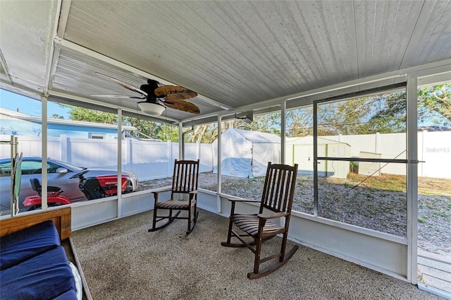 sunroom featuring wood ceiling, plenty of natural light, and ceiling fan