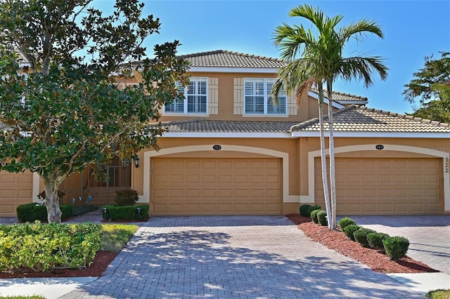 mediterranean / spanish-style home with a garage