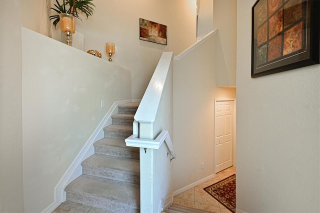 staircase featuring tile patterned floors