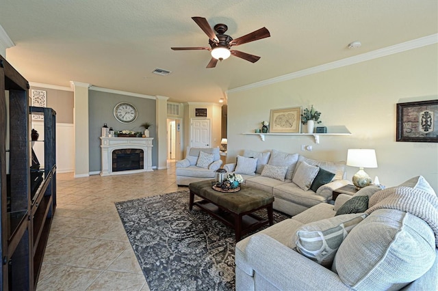 living room with light tile patterned floors, a textured ceiling, ornamental molding, and ceiling fan