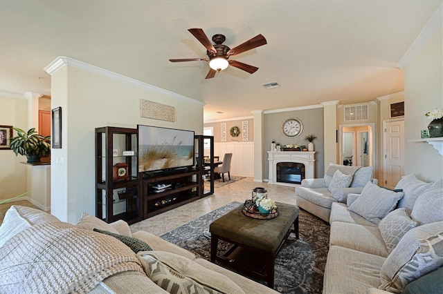 living room with crown molding, ceiling fan, decorative columns, and light tile patterned floors