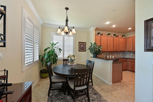 dining space with crown molding, sink, light tile patterned floors, and an inviting chandelier