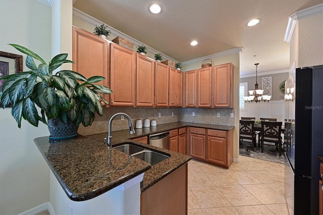 kitchen featuring kitchen peninsula, sink, hanging light fixtures, and dark stone countertops