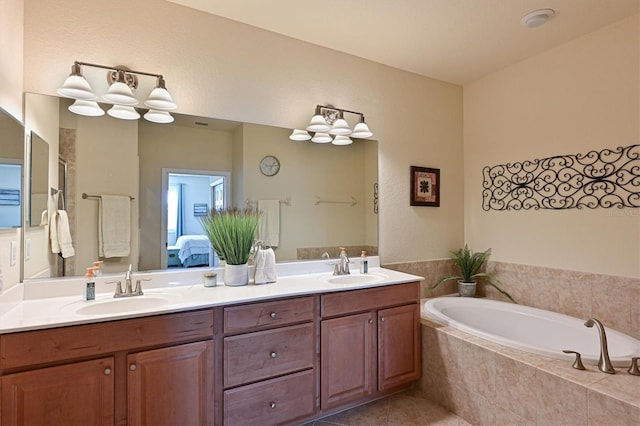 bathroom with a relaxing tiled tub, vanity, an inviting chandelier, and tile patterned flooring