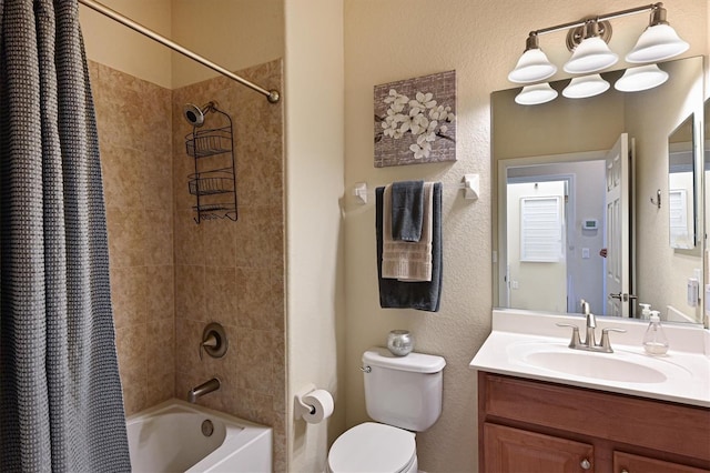 full bathroom with vanity, shower / bath combination with curtain, and toilet