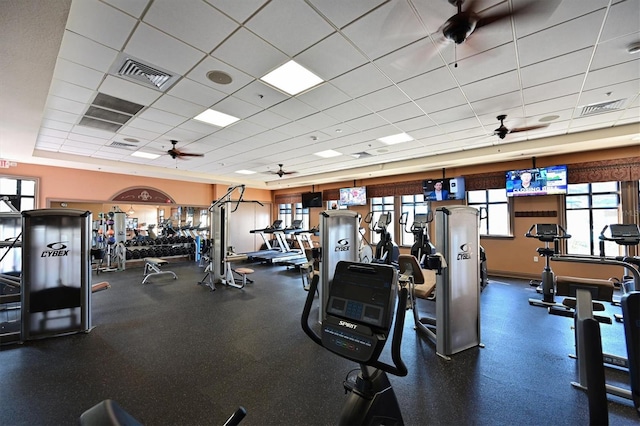 gym with ceiling fan and a paneled ceiling