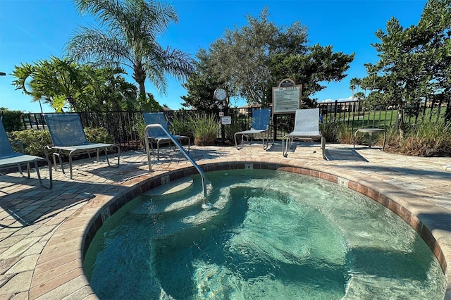 view of swimming pool with a patio area and a hot tub