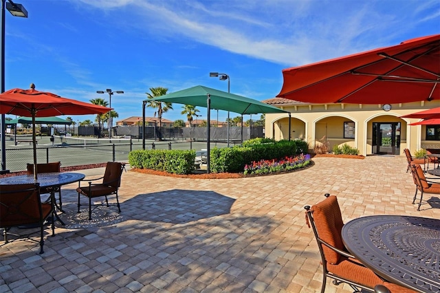 surrounding community featuring tennis court