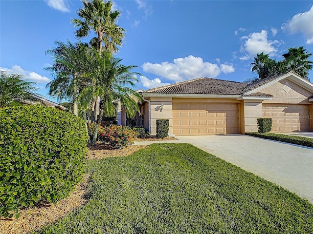 view of front of property with a garage and a front lawn