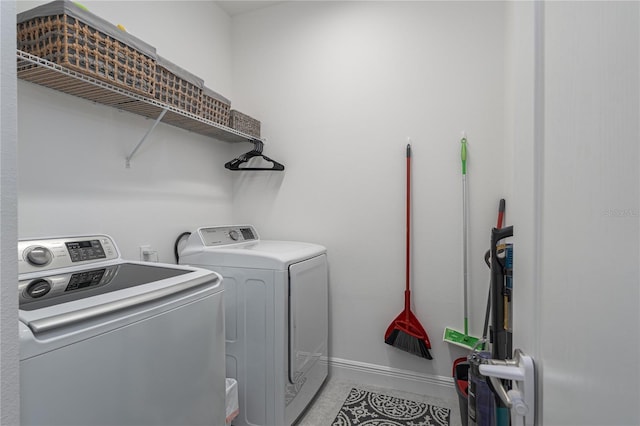 laundry room with separate washer and dryer and light tile patterned floors