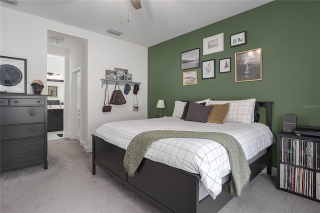 bedroom featuring light carpet and ceiling fan