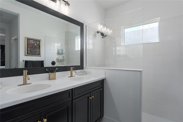 bathroom with vanity and a tile shower