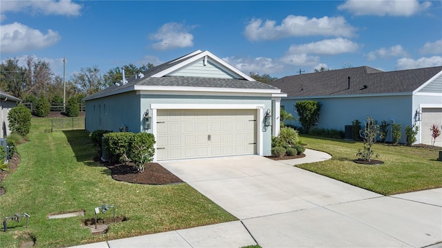 single story home with a garage and a front lawn