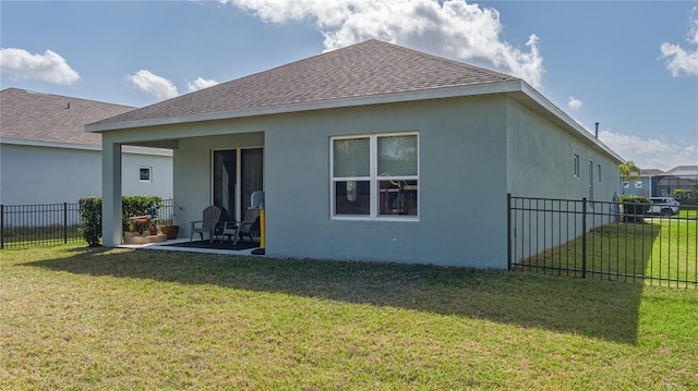 rear view of property featuring a yard