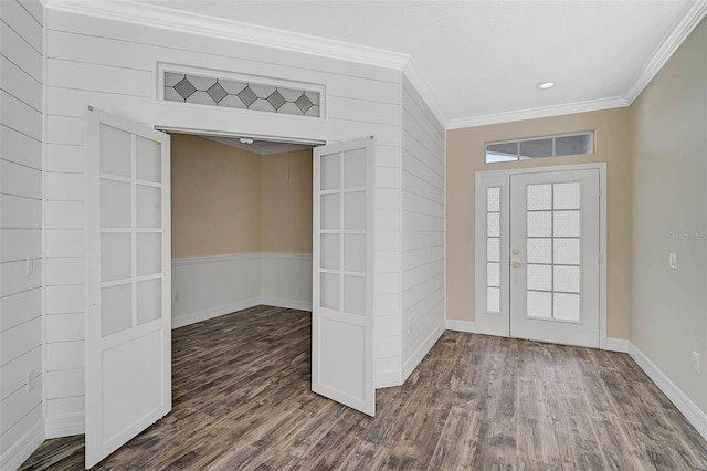 entrance foyer featuring ornamental molding, dark wood-type flooring, visible vents, and baseboards