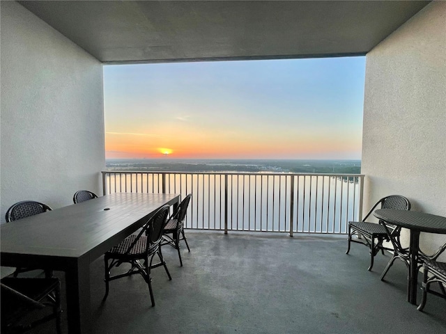 balcony at dusk with a water view