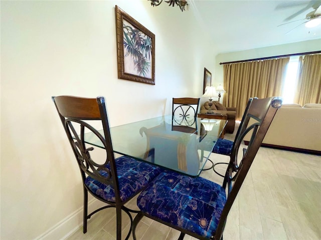 dining area with baseboards and a ceiling fan