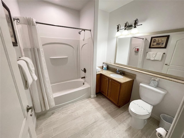 bathroom with toilet, shower / tub combo, and vanity